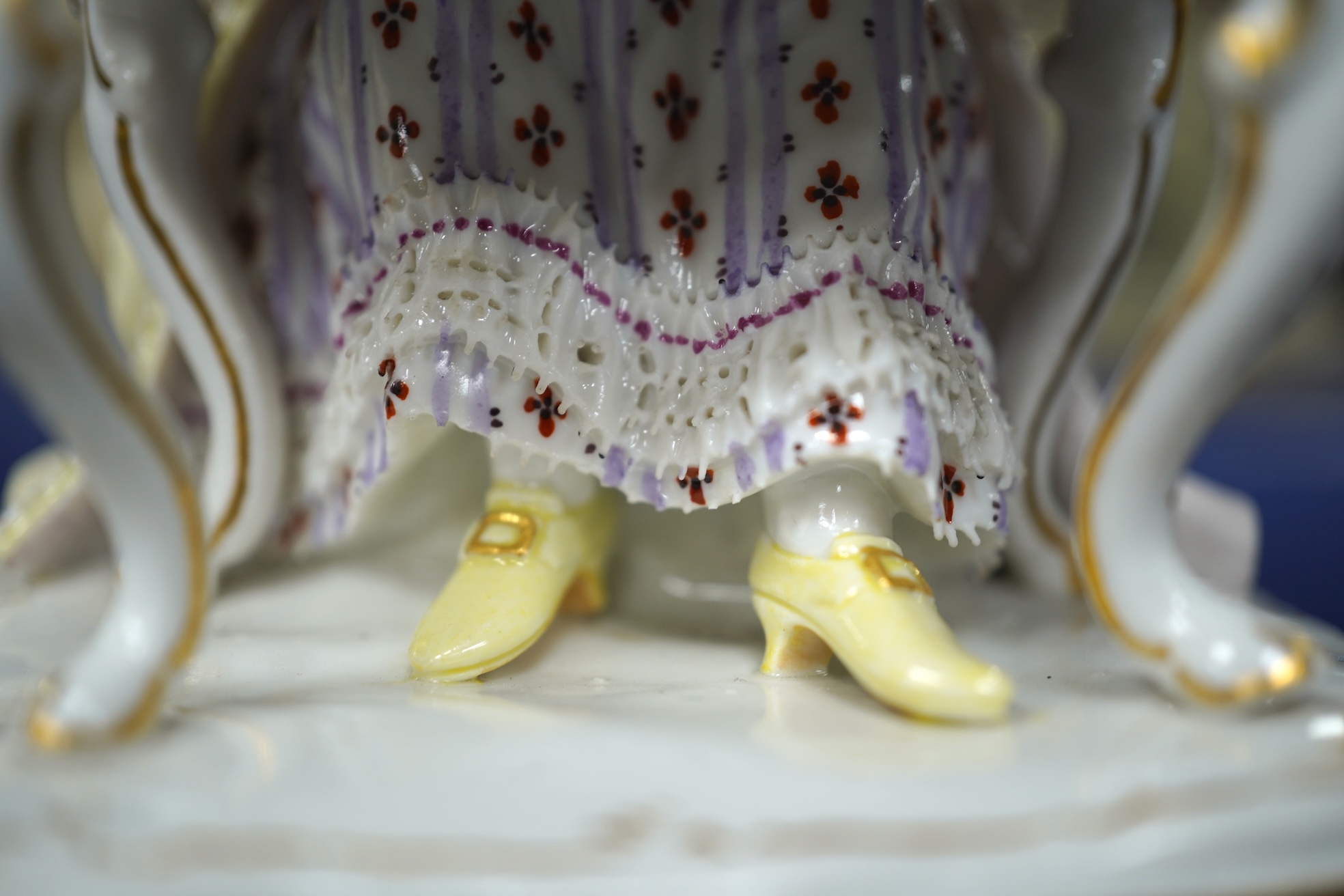 A pair of 19th century Meissen figures of a girl holding a shell and a boy holding a book, in size model number 628, tallest 13cm